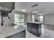 Open-concept kitchen showcasing granite counters, a kitchen island, and access to a spacious living area at 7914 Willow Wind Cir, Indianapolis, IN 46239