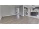 Open concept floor plan featuring new flooring and a view into the kitchen with modern appliances at 7914 Willow Wind Cir, Indianapolis, IN 46239