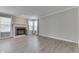 Spacious living room featuring a brick fireplace, ample natural light, and modern flooring at 7914 Willow Wind Cir, Indianapolis, IN 46239