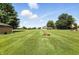 Expansive backyard featuring mature trees, fire pit and storage shed at 8030 5 Points Rd, Indianapolis, IN 46259