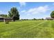 Large backyard area features a storage shed, fire pit and lush greenery at 8030 5 Points Rd, Indianapolis, IN 46259