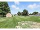 Spacious backyard featuring a storage shed, play set, and well manicured lawn at 8030 5 Points Rd, Indianapolis, IN 46259