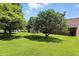 Well-maintained backyard featuring lush green lawn, mature trees, and a charming patio area perfect for outdoor enjoyment at 8030 5 Points Rd, Indianapolis, IN 46259