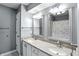 Elegant bathroom features double sinks, granite countertops and decorative mirrors at 8030 5 Points Rd, Indianapolis, IN 46259
