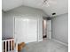 A Bedroom featuring vaulted ceilings, a closet with folding doors and neutral gray walls at 8030 5 Points Rd, Indianapolis, IN 46259