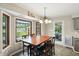 Dining room featuring a bay window with backyard view and a chandelier over the dining table at 8030 5 Points Rd, Indianapolis, IN 46259
