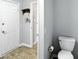 Split image showcasing the entryway and a half bath with white toilet at 8030 5 Points Rd, Indianapolis, IN 46259