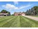 Charming brick ranch home with a well-manicured lawn and a long driveway leading to an attached two car garage at 8030 5 Points Rd, Indianapolis, IN 46259