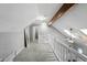 Upstairs hallway has neutral paint, white railing, and a ceiling fan at 8030 5 Points Rd, Indianapolis, IN 46259