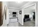 Hallway showcasing neutral paint, leading to living room with a fireplace and a kitchen with updated appliances at 8030 5 Points Rd, Indianapolis, IN 46259