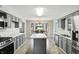 Open kitchen with gray cabinets, stainless steel appliances, and a kitchen island at 8030 5 Points Rd, Indianapolis, IN 46259