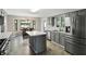 Modern kitchen with gray cabinets, stainless steel appliances, bay windows with backyard view at 8030 5 Points Rd, Indianapolis, IN 46259