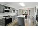 Spacious kitchen with gray cabinets, stainless steel appliances, and bay windows with backyard view at 8030 5 Points Rd, Indianapolis, IN 46259
