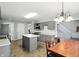 Open-concept kitchen featuring gray cabinets, stainless steel appliances, and a kitchen island at 8030 5 Points Rd, Indianapolis, IN 46259