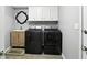 Laundry room featuring modern washer and dryer appliances and vanity and accent mirror at 8030 5 Points Rd, Indianapolis, IN 46259