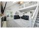 Cozy living room featuring vaulted ceilings, a fireplace, a staircase leading to the upper level, and open kitchen at 8030 5 Points Rd, Indianapolis, IN 46259