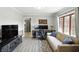 Bright living room with neutral walls, modern flooring, comfortable seating, and view to kitchen at 8030 5 Points Rd, Indianapolis, IN 46259