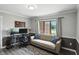 The living room has lots of light, neutral walls, modern flooring, comfortable seating, and a large window at 8030 5 Points Rd, Indianapolis, IN 46259