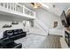 Bright living room with vaulted ceilings, a staircase, a fireplace, and luxury vinyl plank flooring at 8030 5 Points Rd, Indianapolis, IN 46259