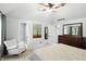 Bright and airy main bedroom boasts a ceiling fan, soothing gray walls and a rocking chair at 8030 5 Points Rd, Indianapolis, IN 46259