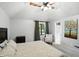 Spacious main bedroom featuring vaulted ceilings, soft neutral colors, and a cozy armchair at 8030 5 Points Rd, Indianapolis, IN 46259