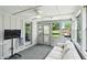 Sunroom with large windows, ceiling fan, and an exterior door providing lots of natural light at 8030 5 Points Rd, Indianapolis, IN 46259