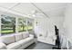Bright sunroom with large windows, ceiling fan, and plush seating area at 8030 5 Points Rd, Indianapolis, IN 46259