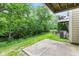 View of backyard featuring patio space, mature trees, grassy slope and balcony at 9046 Sparta Dr, Fishers, IN 46038