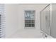 Elegant bathtub with a shower and a window offering natural light in the Primary bathroom at 9046 Sparta Dr, Fishers, IN 46038