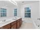 Bright bathroom featuring a double vanity, large mirror, and natural light from the window at 9046 Sparta Dr, Fishers, IN 46038