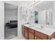 Bathroom vanity with double sinks, vanity cabinets, and an open view to the bedroom at 9046 Sparta Dr, Fishers, IN 46038