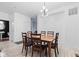 Dining room features wood table with six chairs and a modern light fixture, next to the doorway to a bathroom at 9046 Sparta Dr, Fishers, IN 46038