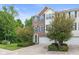 Townhome exterior features well-maintained brick and siding, an attached garage, and lush landscaping at 9046 Sparta Dr, Fishers, IN 46038
