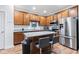 Bright kitchen with stainless steel appliances, wood cabinets, granite counters, and a center island with seating at 9046 Sparta Dr, Fishers, IN 46038