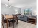 Open-concept living and dining area featuring a table with chairs, comfortable seating, and natural light from a large window at 9046 Sparta Dr, Fishers, IN 46038