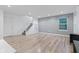 Bright living area with wood-look flooring, staircase, and large window, offering a welcoming atmosphere at 9046 Sparta Dr, Fishers, IN 46038
