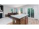 Open floor plan features a granite kitchen island with seating and a spacious living room with a brown leather sofa at 9046 Sparta Dr, Fishers, IN 46038