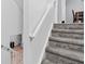 Carpeted staircase with white railing, providing a safe and stylish transition between floors at 9046 Sparta Dr, Fishers, IN 46038