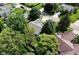 An aerial view of a home with lush landscaping and mature trees in a residential neighborhood at 9170 Andiron Way, Indianapolis, IN 46250