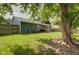 Spacious backyard with mature trees, lush grass, a deck and a wood fence offering privacy and a serene outdoor setting at 9170 Andiron Way, Indianapolis, IN 46250