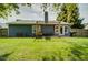 Expansive backyard showcases a well-kept lawn and a cozy pergola-covered deck, ideal for outdoor enjoyment and entertaining at 9170 Andiron Way, Indianapolis, IN 46250