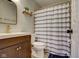 Modern bathroom featuring a stylish vanity, framed mirror, toilet and a shower with a striped curtain and gold hardware at 9170 Andiron Way, Indianapolis, IN 46250