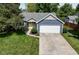 Beautiful home featuring a two-car garage, yellow door and a lush lawn with mature trees at 9170 Andiron Way, Indianapolis, IN 46250