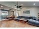 Bright open-concept living area with wood floors, vaulted ceiling and spacious sectional sofa with a dining area at 9170 Andiron Way, Indianapolis, IN 46250