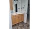 Bathroom featuring a vanity with oak cabinets, a large mirror, and a patterned tile floor at 922 Eagle Brook Dr, Shelbyville, IN 46176
