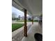 View from the porch that features stone trim and wooden beams, looking out into the neighborhood at 922 Eagle Brook Dr, Shelbyville, IN 46176