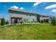 Spacious backyard with green grass, featuring a gazebo and garden beds on a sunny day at 9407 Casey Rd, Pendleton, IN 46064