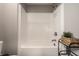 Clean white bathtub with shower, accented with greenery and modern black shelving and fixtures at 9407 Casey Rd, Pendleton, IN 46064
