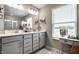 Bathroom with double sinks, bright lighting, window and white countertop at 9407 Casey Rd, Pendleton, IN 46064
