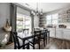 Inviting dining area with modern chandelier, access to outdoor area, and built-in shelving at 9407 Casey Rd, Pendleton, IN 46064
